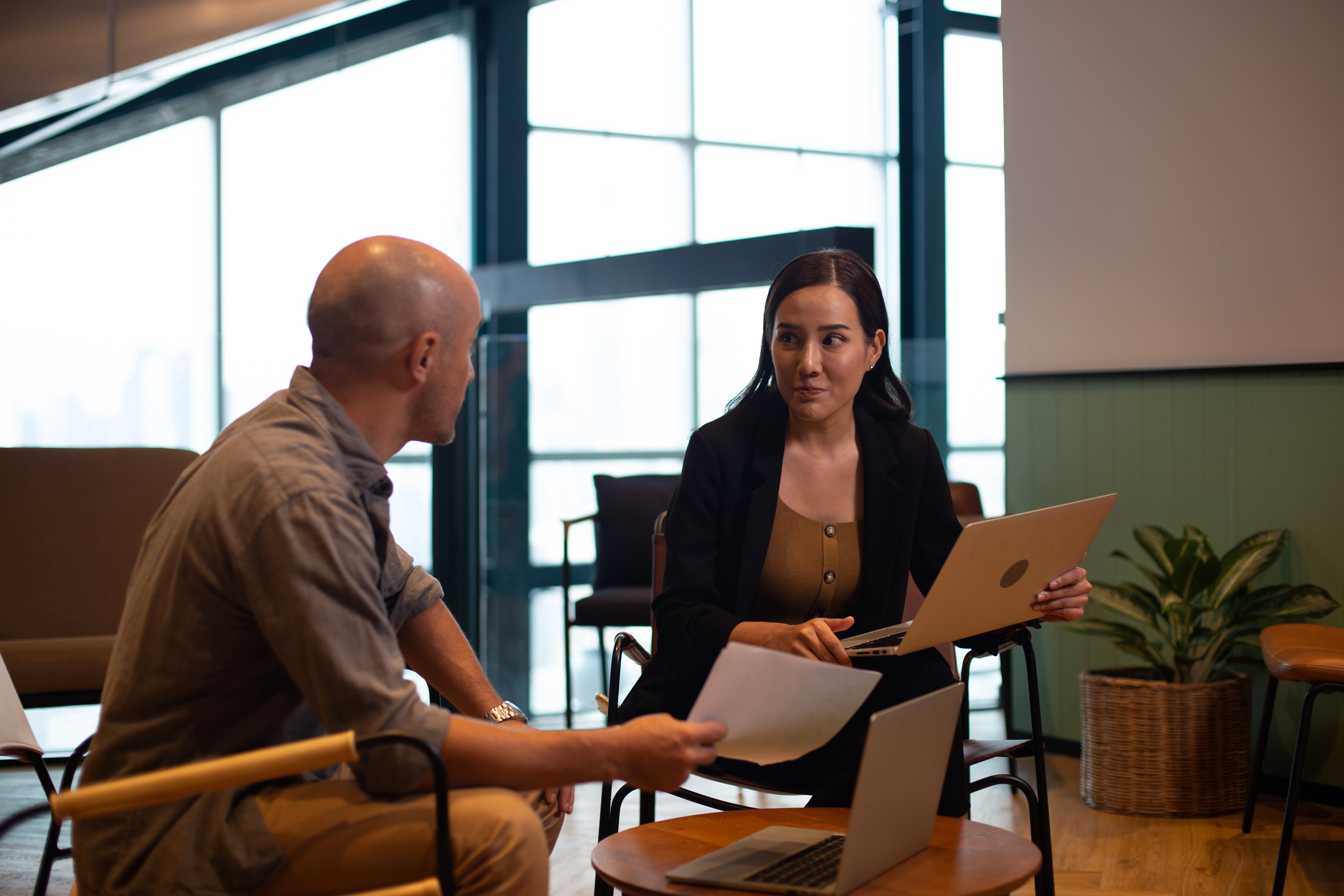 Two people comparing a business profile